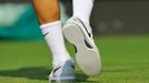 Roger Federer of Switzerland wears new shoes for his men's singles tennis match against Sergiy Stakhovsky of Ukraine at the Wimbledon Tennis Championships, in London June