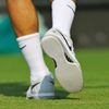 Roger Federer of Switzerland wears new shoes for his men's s