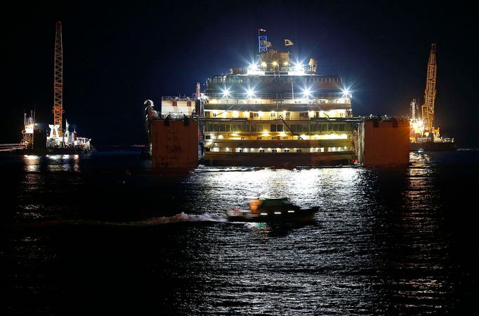 The Costa Concordia cruise liner is seen at Giglio harbour at Giglio Island, late July 17, 2014.