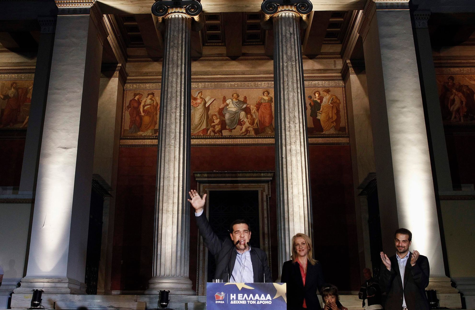 Leader of leftist Syriza party Tsipras waves as he celebrates with newly elected governor of the wider Athens region Dourou, and mayoral runner up for the city of Athens Sakellaridis, in Athens
