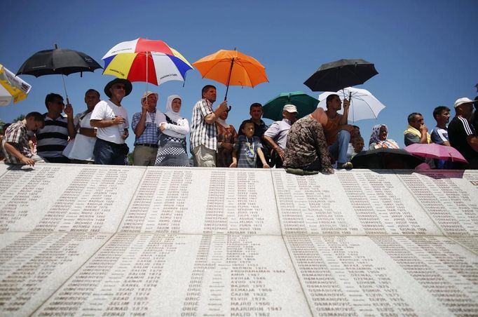 Bosnian Muslims observe a prayer session near a memorial plaque at Memorial Center in Potocari during a mass burial, near Srebrenica July 11, 2012. The bodies of 520 recently identified victims of the Srebrenica massacre is buried on July 11, the anniversary of the massacre when Bosnian Serb forces commanded by Ratko Mladic slaughtered 8,000 Muslim men and boys and buried them in mass graves, in Europe's worst massacre since World War Two. REUTERS/Dado Ruvic (BOSNIA - Tags: CONFLICT OBITUARY ANNIVERSARY TPX IMAGES OF THE DAY)