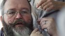 German hairdresser Elmar Weisser, 48, is reflected in a mirror in his hotel room as he starts shaping his beard as a stork, with help from his wife, to compete in the 2012 European Beard and Moustache Championships in Wittersdorf near Mulhouse, Eastern France, September 22, 2012. Weisser, who won the World Beard and Moustache Championship in 2011, ranked second in the freestyle category of the European championships on Saturday. Picture taken September 22, 2012. REUTERS/Vincent Kessler (FRANCE - Tags: SOCIETY) Published: Zář. 23, 2012, 12:13 odp.