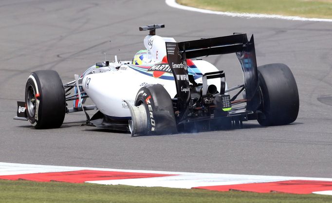 Williams Formula One team driver Felipe Massa drives his damaged car during the British Grand Prix at the Silverstone Race Circuit, central England, July 6, 2014. REUTERS