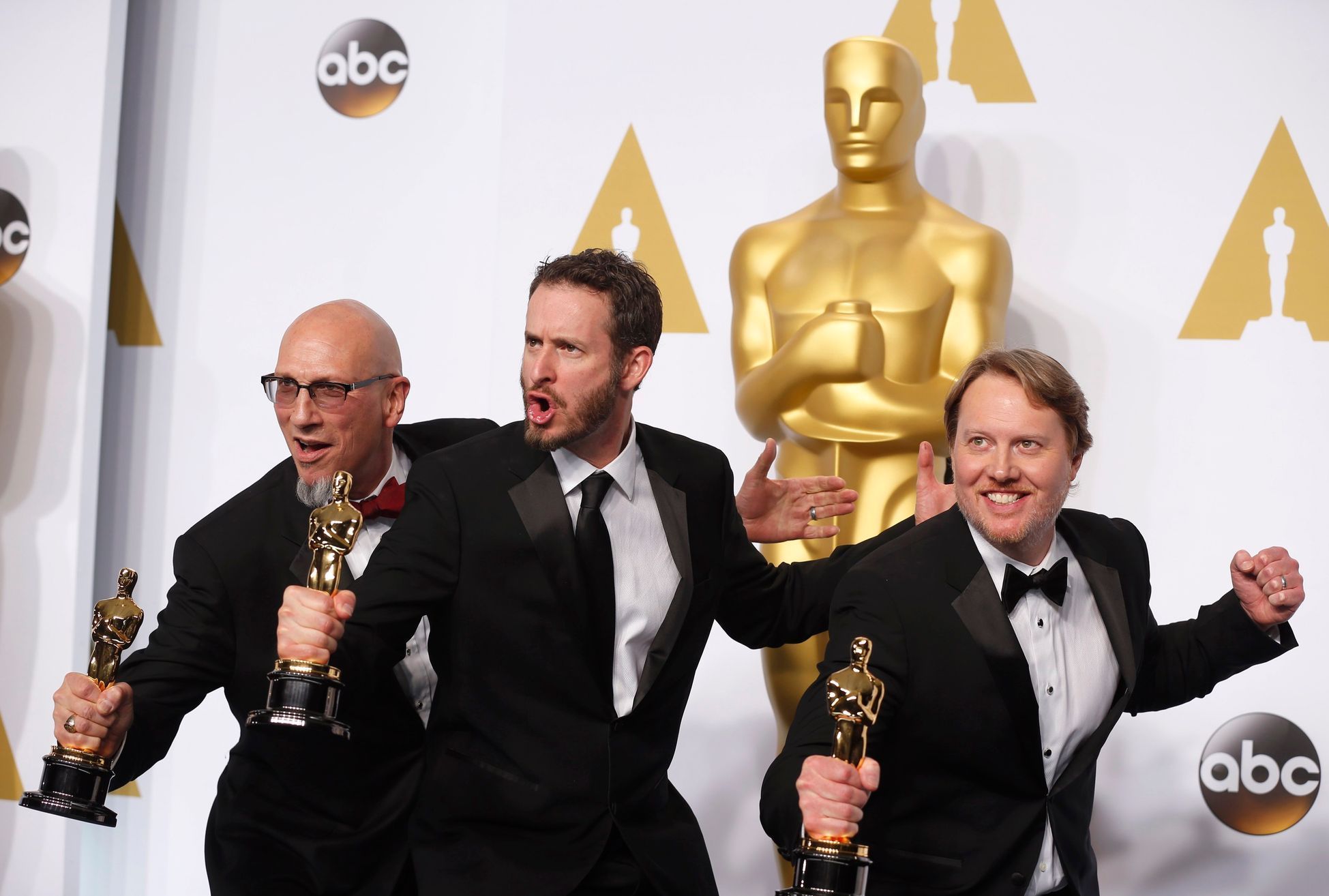 Ron Conli (L), Chris Williams and Don Hall pose with their award for best animated feature film for &quot;Big Hero 6&quot; during the 87th Academy Awards in Hollywood, California