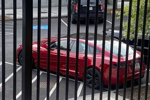 A Tesla vehicle is parked on West Executive Avenue near the White House in Washington