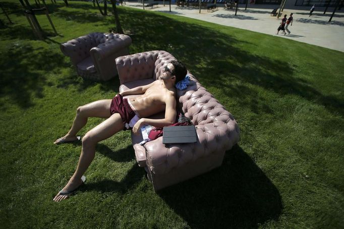 Amini Fonua, a swimmer from Tonga, sunbathes at the Athletes' Village at the Olympic Park in London, July 22, 2012. Opening ceremonies for the London 2012 Olympics will be held on Friday. REUTERS/Jae C. Hong/Pool (BRITAIN - Tags: SPORT OLYMPICS SWIMMING) Published: Čec. 22, 2012, 4:08 odp.