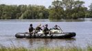 German Bundeswehr armed forces soldiers use a boat as they check a damaged dyke at the river Elbe at the village of Hohengoehren, north of Magdeburg June 10, 2013. Tens of thousands of people have been forced to leave their homes and there have been at least a dozen deaths as a result of floods that have hit Germany, Austria, Slovakia, Poland and the Czech Republic over the past week. REUTERS/Fabrizio Bensch (GERMANY - Tags: DISASTER ENVIRONMENT)