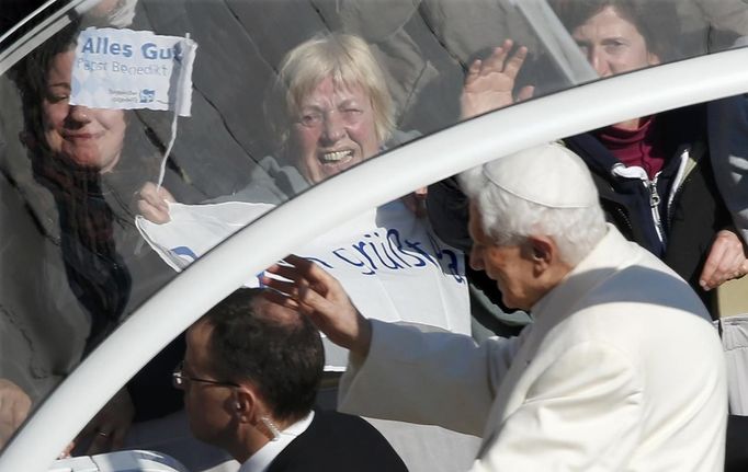 Pope Benedict XVI waves from his Popemobile as he rides through a packed Saint Peter's Square at the Vatican during his last general audience, February 27, 2013. The weekly event which would normally be held in a vast auditorium in winter, but has been moved outdoors to St. Peter's Square so more people can attend. The pope has two days left before he takes the historic step of becoming the first pontiff in some six centuries to step down instead of ruling for life. REUTERS/Tony Gentile (VATICAN - Tags: RELIGION)