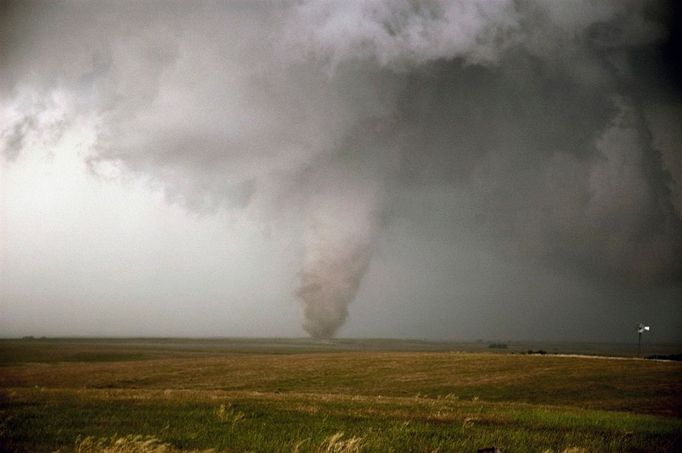 Strong tornado, F-3, rips across farmland just southwest of Hill City, Kansas in early June.