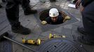 Policemen check a drain outside the Santiago Bernabeu stadium before the 'Clasico' soccer match between Real Madrid and Barcelona in Madrid, Spain, November 21, 2015. REU