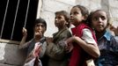 Girls wait for food rations outside a charity food assistance center in Yemen's capital Sanaa July 1, 2015.