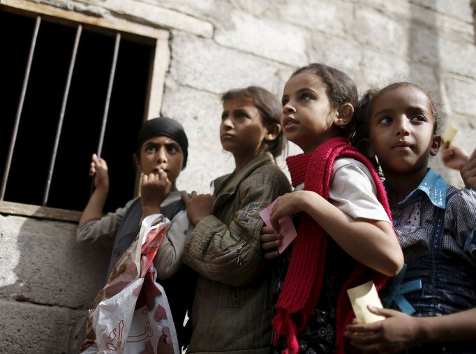 Girls wait for food rations outside a charity food assistance center in Yemen's capital Sanaa July 1, 2015.