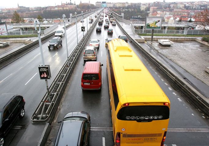 Žlutý autobus vjíždí na Nuselský most a do Prahy. Student Agency denně vypraví 80 autobusů jedním nebo druhým směrem po D1.