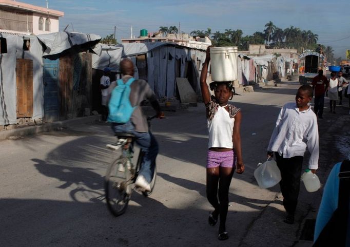 Žádné prázdniny. Děti ze zemětřesením zdecimovaného Haiti shání v Port-au-Prince pitnou vodu.