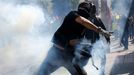 A demonstrator throws a tear gas bomb after military police shot at demonstrators during a protest against the 2014 World Cup, in Sao Paulo June 12, 2014. REUTERS/Nacho D