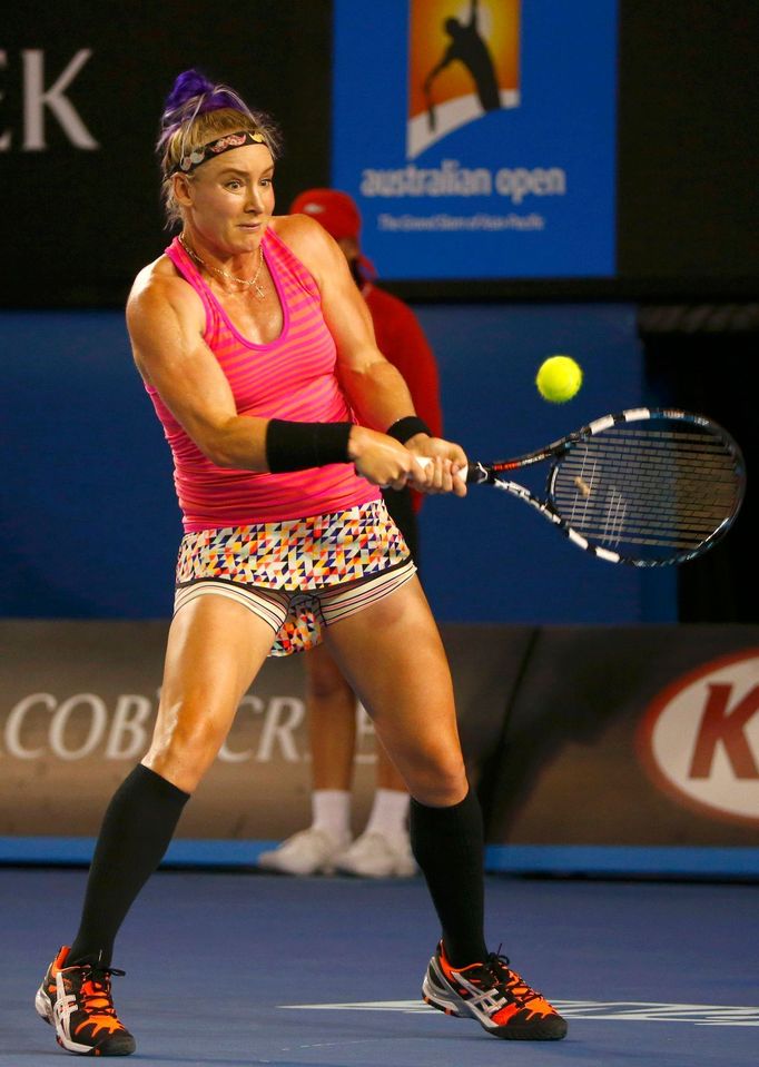 Bethanie Mattek-Sands of the United States hits a return to Maria Sharapova of Russia during their women's singles match at the Australian Open 2014 tennis tournament in