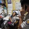 A policeman (R) talks on a phone as preacher Jeong Young-ran looks on after a mother abandoned her baby at a "baby box" at Joosarang church in Seoul September 18, 2012. A South Korean pastor who runs a "baby box" where mothers can leave unwanted infants has seen a sharp increase in the number of newborns being left there because, the pastor says, of a new law aimed protecting the rights of children. South Korea is trying to shed a reputation of being a source of babies for adoption by people abroad. It is encouraging domestic adoption and tightening up the process of a child's transfer from birth mother to adoptive parents. Picture taken September 18, 2012. REUTERS/Kim Hong-Ji (SOUTH KOREA - Tags: SOCIETY) Published: Říj. 7, 2012, 6:48 dop.