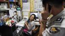 A policeman (R) talks on a phone as preacher Jeong Young-ran looks on after a mother abandoned her baby at a "baby box" at Joosarang church in Seoul September 18, 2012. A South Korean pastor who runs a "baby box" where mothers can leave unwanted infants has seen a sharp increase in the number of newborns being left there because, the pastor says, of a new law aimed protecting the rights of children. South Korea is trying to shed a reputation of being a source of babies for adoption by people abroad. It is encouraging domestic adoption and tightening up the process of a child's transfer from birth mother to adoptive parents. Picture taken September 18, 2012. REUTERS/Kim Hong-Ji (SOUTH KOREA - Tags: SOCIETY) Published: Říj. 7, 2012, 6:48 dop.