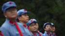 Mid-level government officials dressed in red army uniforms listen to a lesson as they visit an old house where former Chinese leader Mao Zedong used to live, during a five-day training course at the communist party school called China Executive Leadership Academy of Jinggangshan, in Jiangxi province September 21, 2012. China Executive Leadership Academy was established in 2005 by the Central Committee of the Communist Party of China, after the 16th Communist Party Congress in 2002. By the end of August 2012, the academy has held 789 training classes for almost 40,000 people. During the course, trainees listen and sing revolutionary songs, visit old revolutionary sites and review historical communist materials. China has yet to announce the starting date for the 18th Communist Party Congress, China's biggest political meeting in a decade, which will see the transfer of power from President Hu Jintao and Premier Wen Jiabao to a new generation. REUTERS/Carlos Barria (CHINA - Tags: POLITICS SOCIETY) Published: Zář. 21, 2012, 3:25 odp.