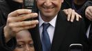 French presidential election candidate Hollande takes pictures with supporters in Aubervilliers