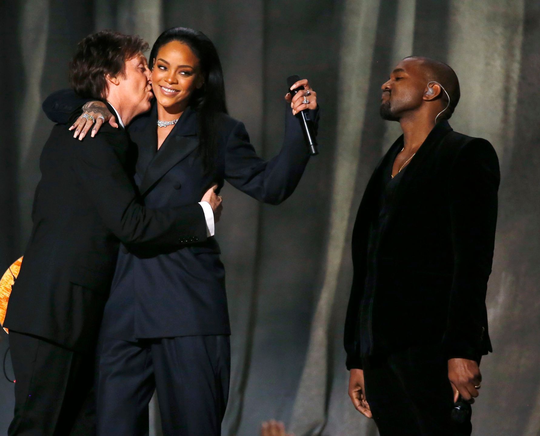 Paul McCartney kisses Rihanna as Kanye West watches after performing &quot;FourFiveSeconds&quot; at the 57th annual Grammy Awards in Los Angeles