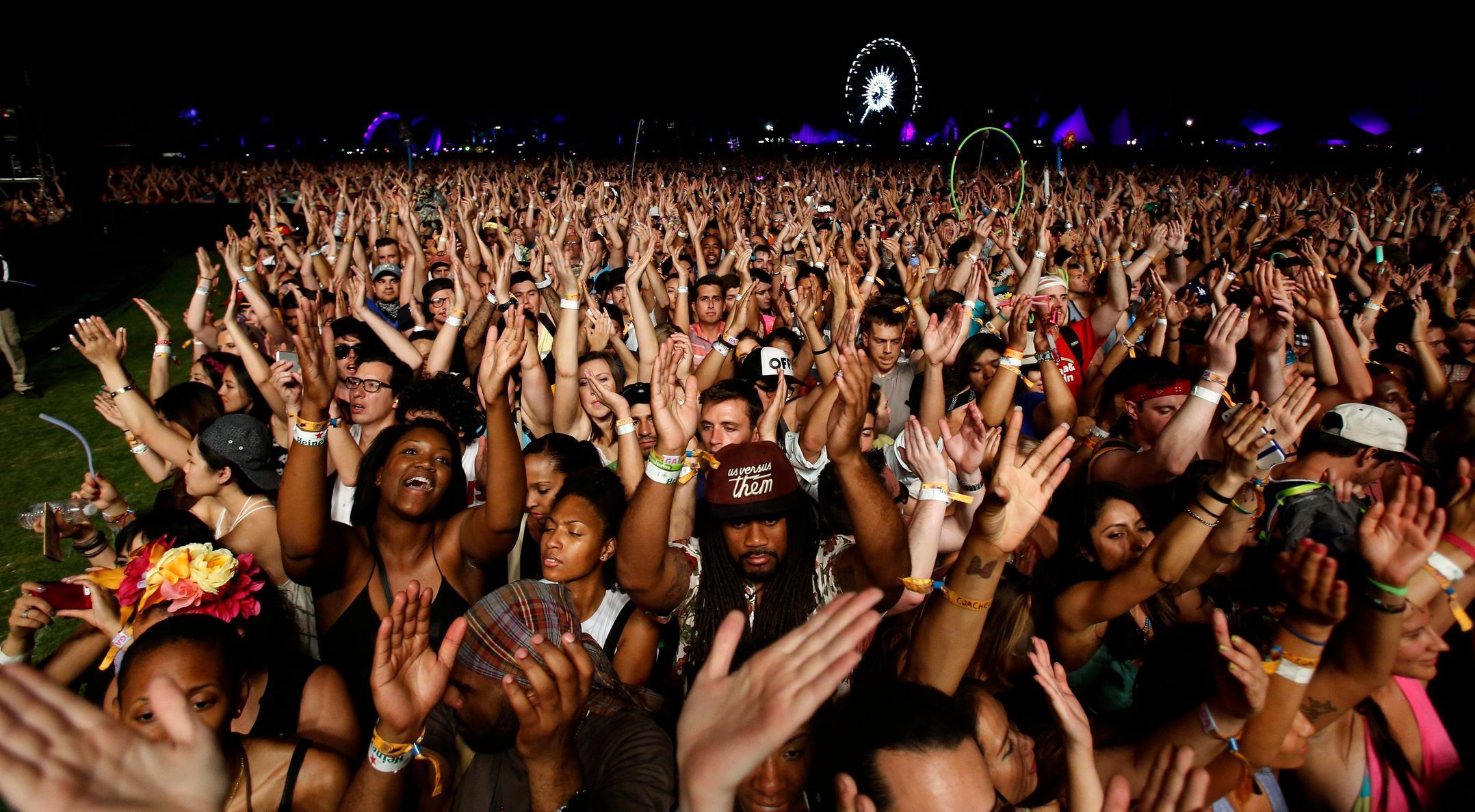 Concert-goers cheer during the performance of Canadian electrofunk duo Chromeo at the Coachella Valley Music and Arts Festival in Indio, California