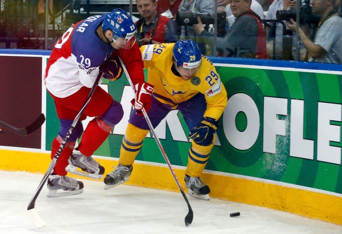 Sweden's Erik Gustafsson (L) is checked into the boards by Jan Kolar of the Czech Republic (R) during the first period of their men's ice hockey World Championship bronze