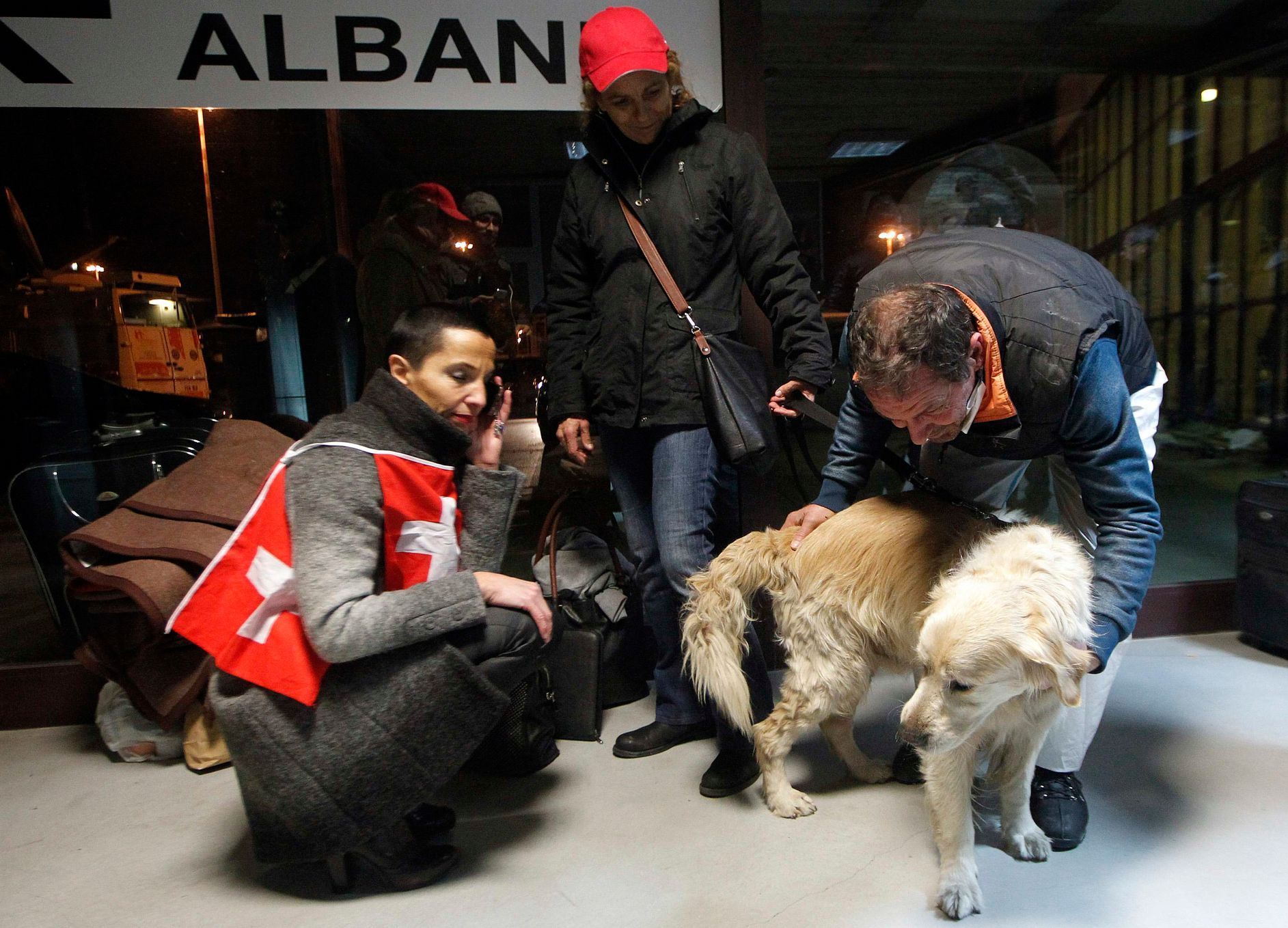 A man stands next to his dog, Victor, after they both survived the fire on car ferry Norman Atlantic, as they leave the Italian Navy San Giorgio amphibious transport ship in the Brindisi harbour