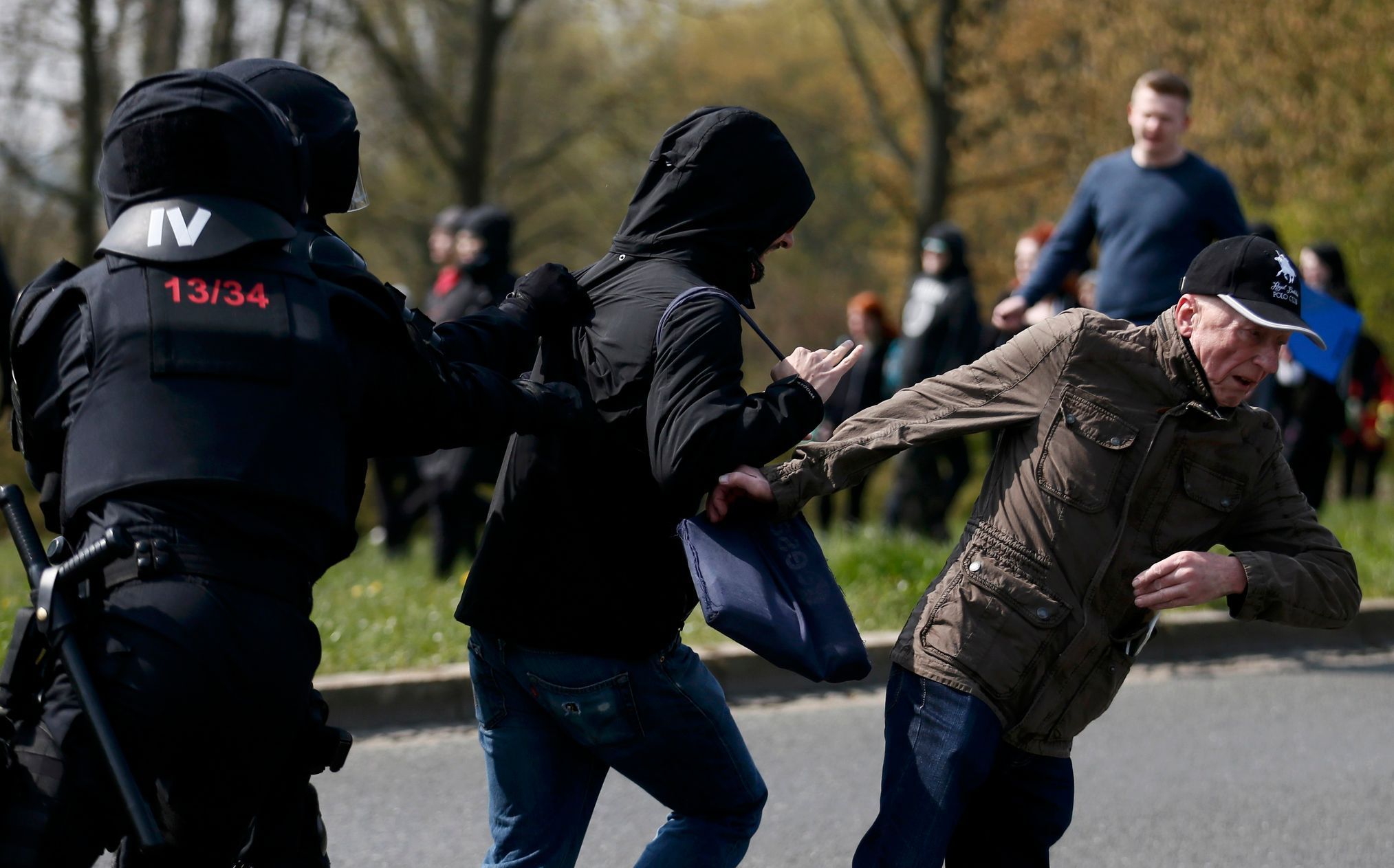 Riot police officers catch left-wing protestors as they try to reach a right-wing demonstration in the town in Plauen