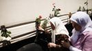 Bosnian women touches one of the three trucks carrying 520 coffins of newly identified victims of the 1995 Srebrenica massacre in front of the presidential building in Sarajevo July 9, 2012. The bodies of the recently identified victims will be transported to the memorial centre in Potocari where they will be buried on July 11 marking the 17th anniversary of the massacre in which Bosnian Serb forces commanded by Ratko Mladic killed up to 8,000 Muslim men and boys and buried them in mass graves. REUTERS/Dado Ruvic (BOSNIA AND HERZEGOVINA - Tags: ANNIVERSARY CIVIL UNREST POLITICS) Published: Čec. 9, 2012, 11:02 dop.