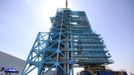 A soldier stands guard in front of the launch pad holding the Long March II-F rocket loaded with the Shenzhou-9 manned spacecraft, in Jiuquan Satellite Launch Center, Gansu province, June 16, 2012. China will send its first woman into outer space this week, prompting a surge of national pride as the rising power takes its latest step towards putting a space station in orbit within the decade. Liu Yang, a 33-year-old fighter pilot, will join two other astronauts aboard the Shenzhou 9 spacecraft when it lifts off from a remote Gobi Desert launch site on Saturday evening. REUTERS/Jason Lee (CHINA - Tags: MILITARY SCIENCE TECHNOLOGY) Published: Čer. 16, 2012, 5:10 dop.