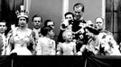 With a charmingly grandmotherly smile, Queen Elizabeth, The Queen Mother, stoops to ask an enchanted Princess Anne whether she is enjoying the RAF fly-past as members of the Royal family stand on the balcony of Buckingham Palace after the Coronation at Westminster Abbey. Prince Charles looks to his father, The Duke of Edinburgh, who smiles down on his daughter, Princess Anne. The Queen, wearing the Imperial state crown, gazes at the crowds milling around the gates of the Palace. Background, left to right, The Duke of Gloucester, uncle of the Queen. 2nd June 1953