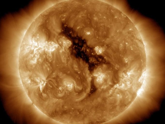 Coronal Hole on the Sun This image of a coronal hole on the sun bears a remarkable resemblance to the 'Sesame Street' character Big Bird. Coronal holes are regions where the sun's corona is dark. These features were discovered when X-ray telescopes were first flown above the Earth's atmosphere to reveal the structure of the corona across the solar disc. Coronal holes are associated with 'open' magnetic field lines and are often found at the sun’s poles. The high-speed solar wind is known to originate in coronal holes. The solar wind escaping from this hole will reach Earth around June 5-7, 2012. Image Credit: NASA/AIA