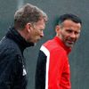 Manchester United's manager Moyes walks past Giggs during a training session at the club's Carrington training complex in Manchester