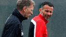 Manchester United's manager Moyes walks past Giggs during a training session at the club's Carrington training complex in Manchester