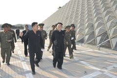 North Korean leader Kim Jong-Un (front C) inspects the construction site of the Munsu Swimming Complex, which is nearing completion, in this undated photo released by Nor