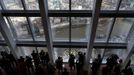 Visitors look out from windows in The View gallery at the Shard in London