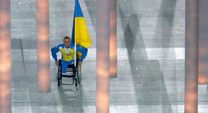 Ukraine's flag-bearer Tkachenko arrives in the stadium during the opening ceremony of the 2014 Paralympic Winter Games in Sochi