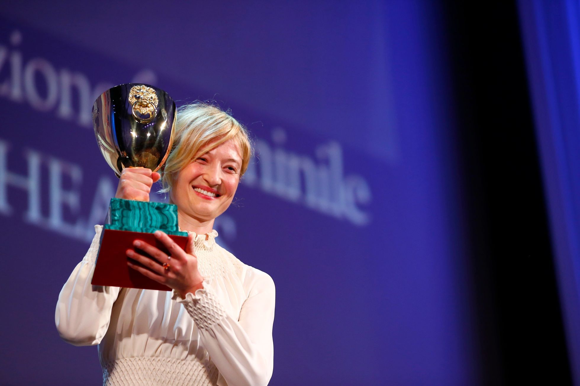 Actress Alba Rohrwacher holds the Volpi Cup prize for best actress for her role in the movie "Hungry Hearts" during the awards ceremony at the 71st Venice Film Festival