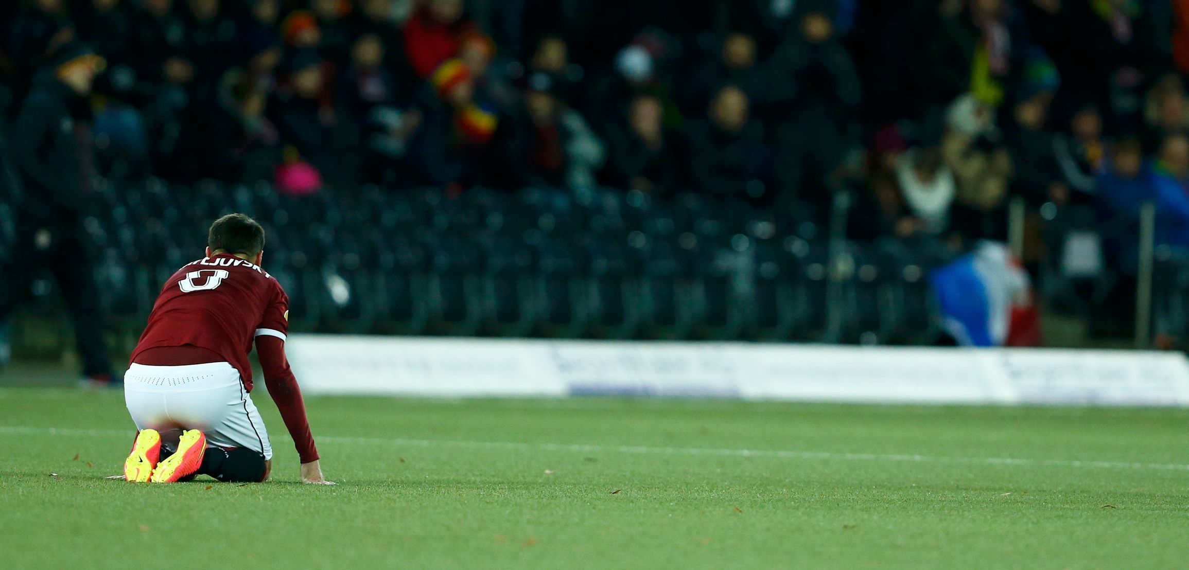 Sparta Prague's Matejovsky kneels on the pitch dejected after losing to BSC Young Boys in Europa League match in Bern