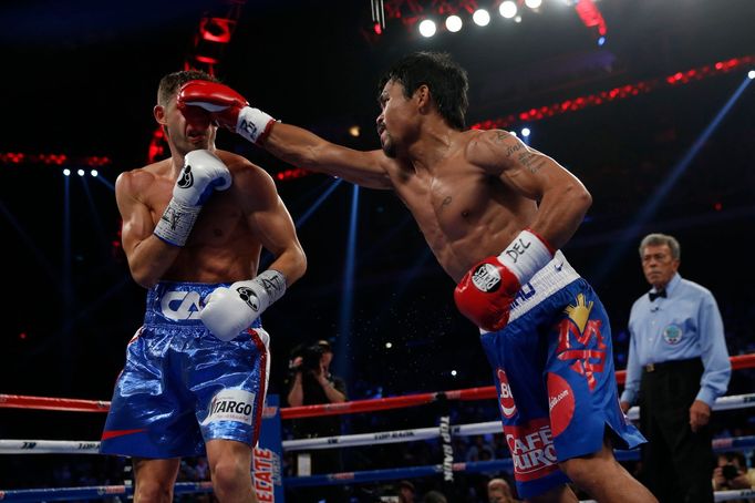 Manny Pacquiao (R) of the Philippines punches Chris Algieri of the U.S. during their World Boxing Organisation (WBO) 12-round welterweight title fight at the Venetian Mac