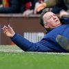 Manchester United manager Louis van Gaal lies on the side of the pitch to demonstrate a foul to the fourth official Mike Dean
