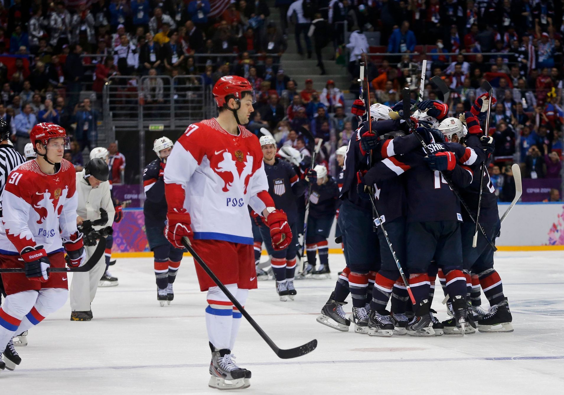 Team USA's Oshie celebrates with teammates next to Russia's Radulov and Tarasenko after scoring the game winning shootout goal against Russia, during their men's preliminary round hockey game at the S