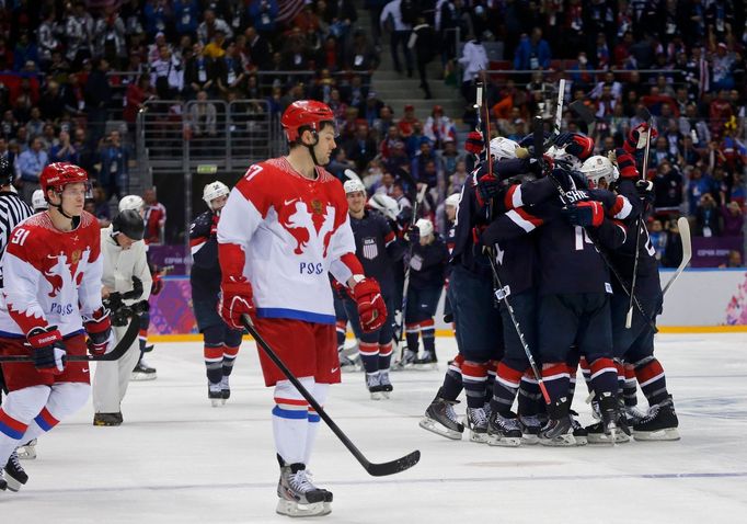 Team USA's T.J. Oshie (2nd R) celebrates with teammates next to Russia's Alexander Radulov (front) and Vladimir Tarasenko (extreme L), after scoring the game winning shoo