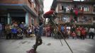 Gchan Choudhary, 17, (L) helps his younger brother Drumpal, 11, to stand on wooden stilts while performing tricks on the street of Kathmandu August 15, 2012. Gchan, Drumpal and their sister Shivani, who came to Kathmandu from India 5 years ago, earn their living by performing tricks on the streets of Kathmandu. According to Drumpal, they earn around $10 a day by performing tricks, which is not enough to feed their 10-member family living together in a small hut without a proper toilet or any basic needs. REUTERS/Navesh Chitrakar (NEPAL - Tags: SOCIETY TPX IMAGES OF THE DAY POVERTY IMMIGRATION) Published: Srp. 15, 2012, 4:24 odp.