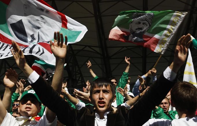 Terek Grozny fans support their team during a soccer match against Amkar Perm at the Akhmad Arena stadium in the Chechen capital Grozny April 27, 2013. The naming of two Chechens, Dzhokhar and Tamerlan Tsarnaev, as suspects in the Boston Marathon bombings has put Chechnya - the former site of a bloody separatist insurgency - back on the world's front pages. Chechnya appears almost miraculously reborn. The streets have been rebuilt. Walls riddled with bullet holes are long gone. New high rise buildings soar into the sky. Spotless playgrounds are packed with children. A giant marble mosque glimmers in the night. Yet, scratch the surface and the miracle is less impressive than it seems. Behind closed doors, people speak of a warped and oppressive place, run by a Kremlin-imposed leader through fear. Picture taken April 27, 2013. REUTERS/Maxim Shemetov (RUSSIA - Tags: SOCIETY POLITICS SPORT) ATTENTION EDITORS: PICTURE 24 OF 40 FOR PACKAGE 'INSIDE MODERN CHECHNYA'. SEARCH 'REBUILDING CHECHNYA' FOR ALL IMAGES Published: Kvě. 1, 2013, 8:04 dop.