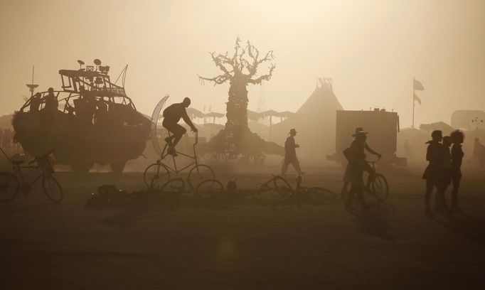 The sun sets during the Burning Man 2012 "Fertility 2.0" arts and music festival in the Black Rock Desert of Nevada August 29, 2012. More than 60,000 people from all over the world have gathered at the sold out festival, which is celebrating its 26th year, to spend a week in the remote desert cut off from much of the outside world to experience art, music and the unique community that develops.