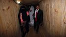 Palestinian groom Emad al-Malalha, 21, walks with Manal Abu Shanar, 17, his Egyptian bride inside a smuggling tunnel beneath the Gaza-Egypt border in the southern Gaza Strip March 21, 2013. Al-Malalha , who said that his bride was not given a permit from Egyptian authorities to enter the Gaza Strip, brought her from neighboring Egypt through a smuggling tunnel to celebrate his wedding in his native Gaza Strip. REUTERS/Ibraheem Abu Mustafa (GAZA - Tags: POLITICS SOCIETY TPX IMAGES OF THE DAY) Published: Bře. 21, 2013, 6:15 odp.