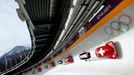 Switzerland's pilot Beat Hefti (front) and his teammates speed down the track during a four-man bobsleigh training session at the Sanki Sliding Center in Rosa Khutor, dur