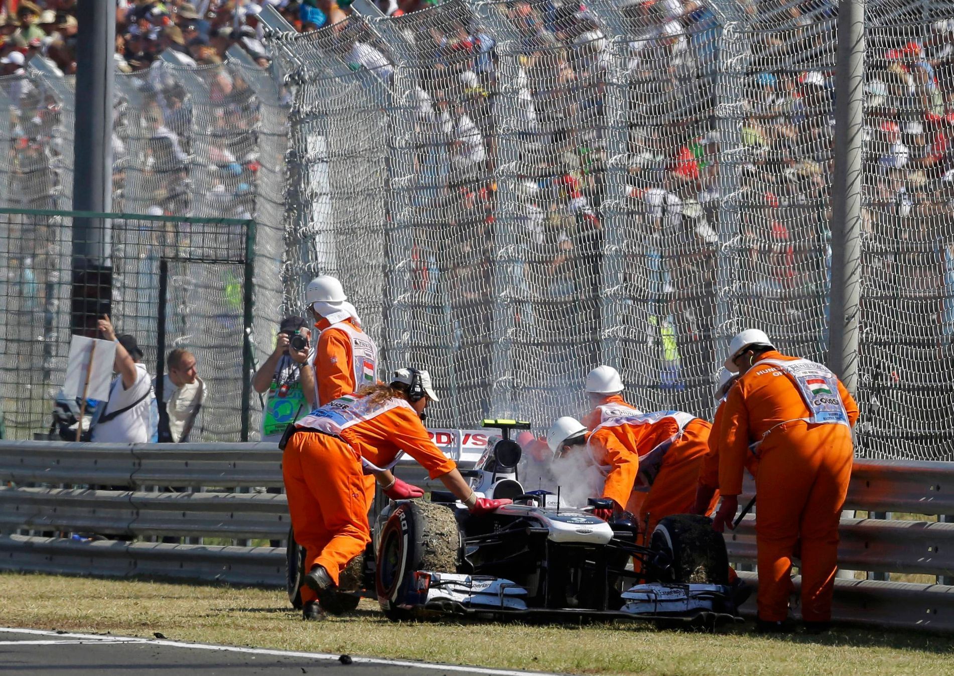 Williams Formula One driver Bottas is pushed out of the track by marshals during the Hungarian F1 Grand Prix in Mogyorod